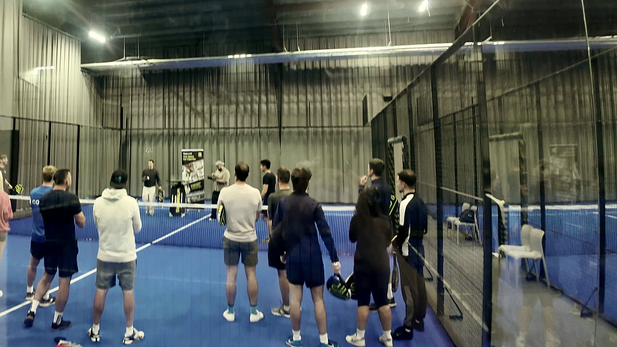 Members gathered on court at a racquet club event run by EMU