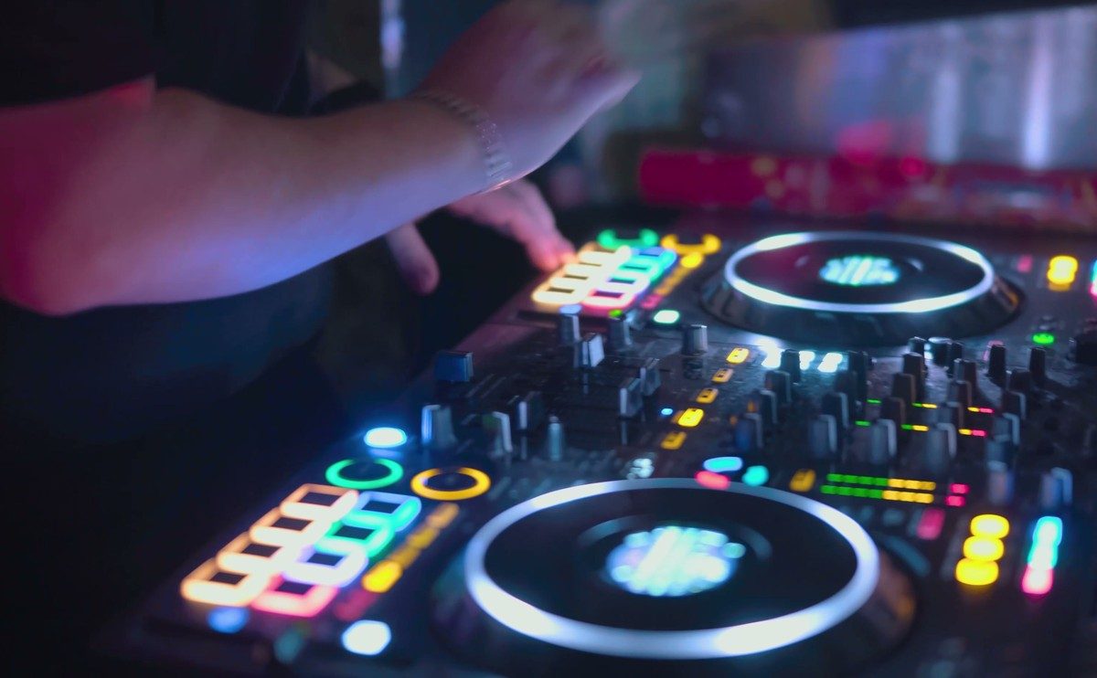 A resident DJ working a lit controller mid-set